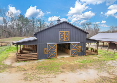 An exterior wide shot of a modern barn