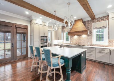 Modern luxury kitchen featuring a large white island with teal barstools