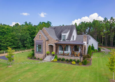 An aerial front-view of a custom 4-bedroom home by Walker Auctions
